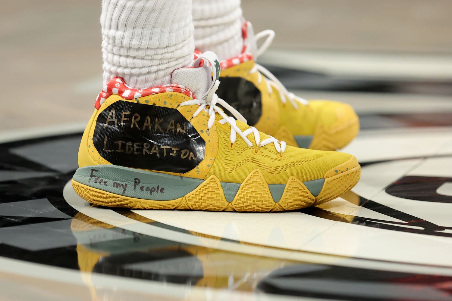 View of yellow and black Nike Kyrie shoes.